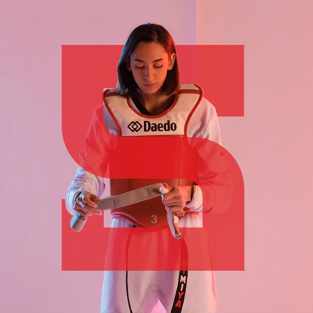 Person wearing a sports outfit with 'Daedo' branding on a pink background