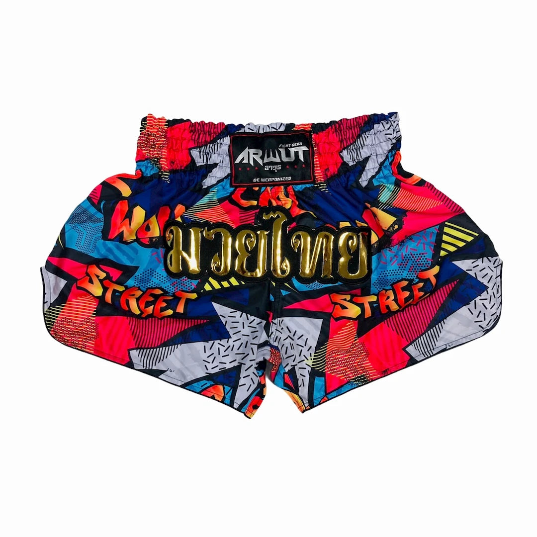 Colorful Muay Thai shorts with abstract patterns and text on a white background
