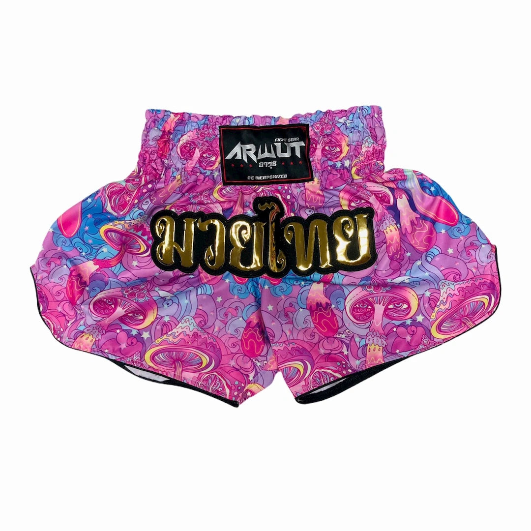 Colorful Muay Thai shorts with a golden Arwut brand label on a white background