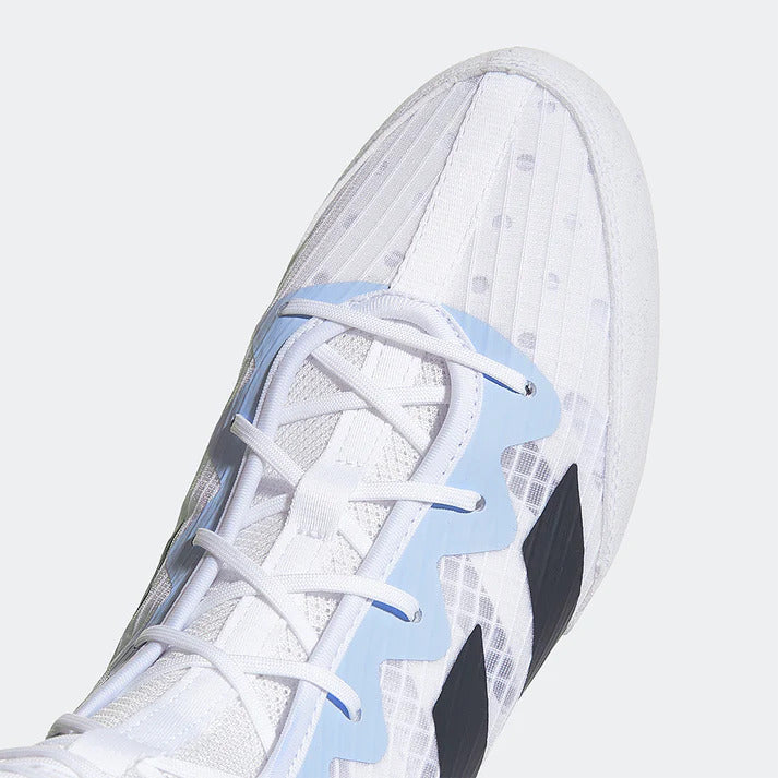 Close-up of a white sneaker with blue accents on a light gray background