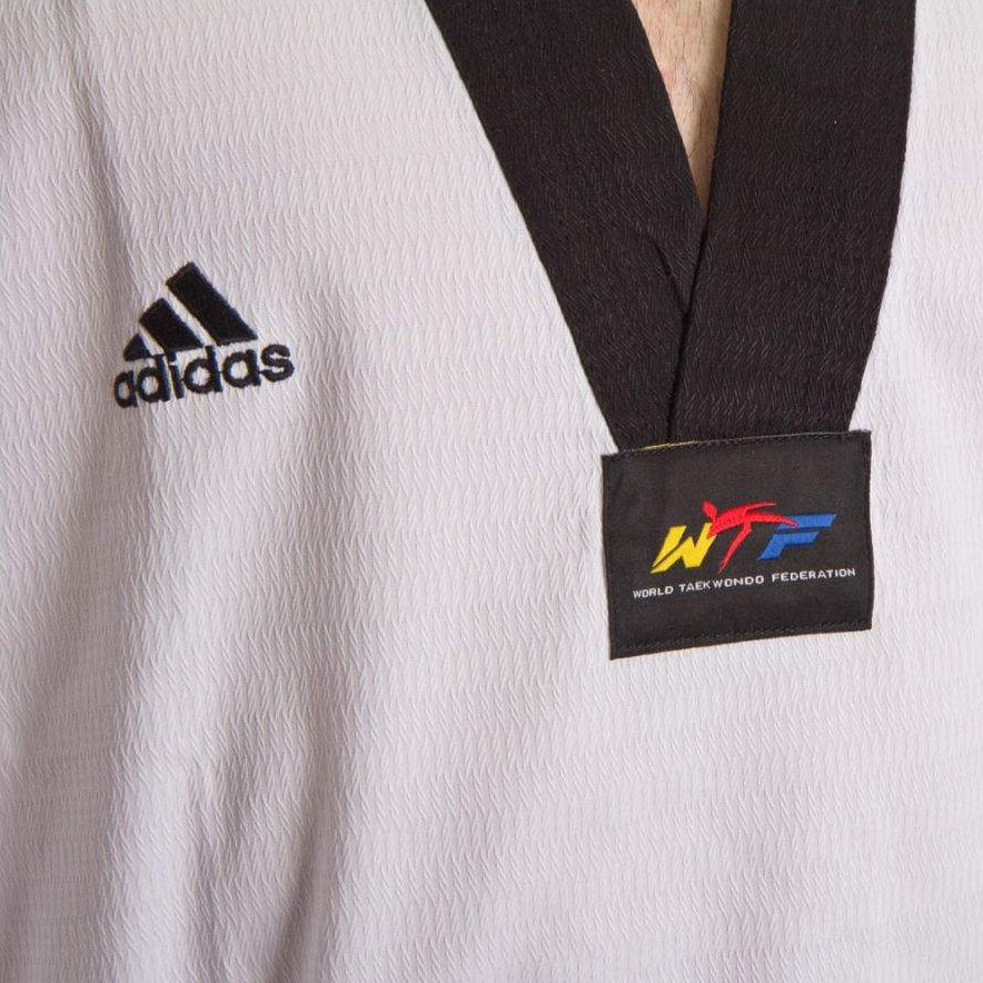 White martial arts uniform with Adidas logo and WTF label on a white background