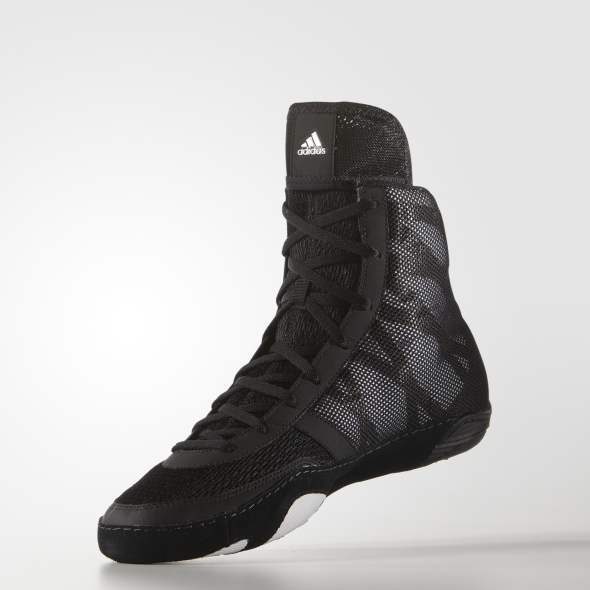 Black Adidas boxing shoe on a light gray background