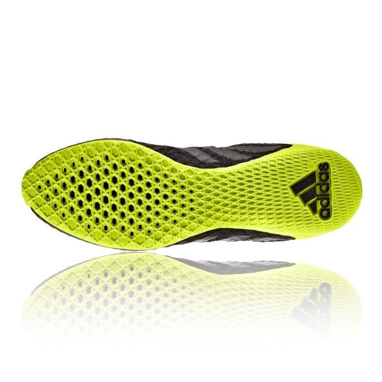 Close-up of a yellow and black Adidas shoe sole on a white background