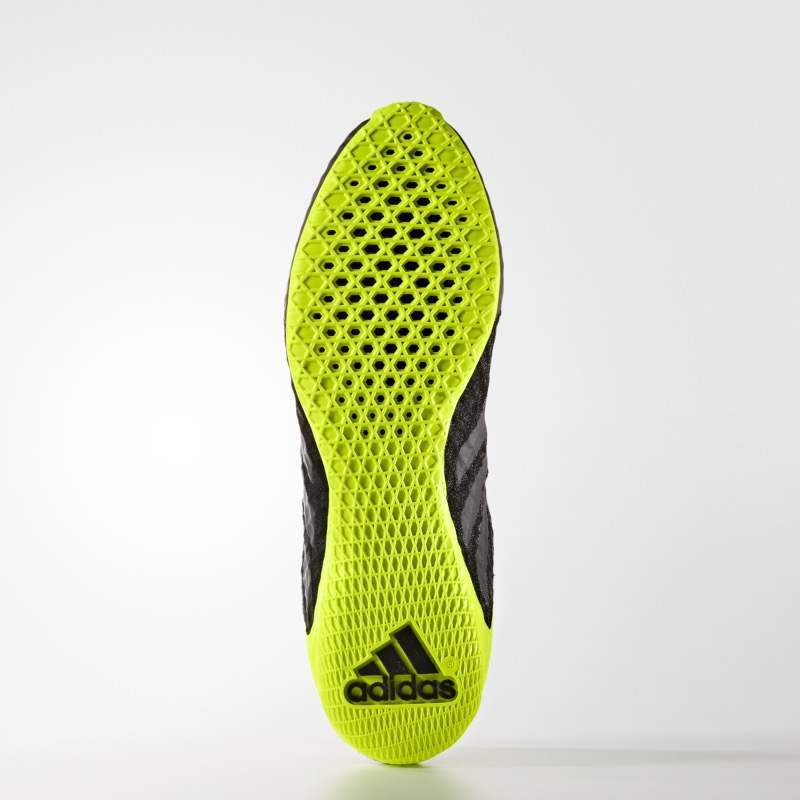 Close-up of a bright yellow Adidas shoe sole on a white background