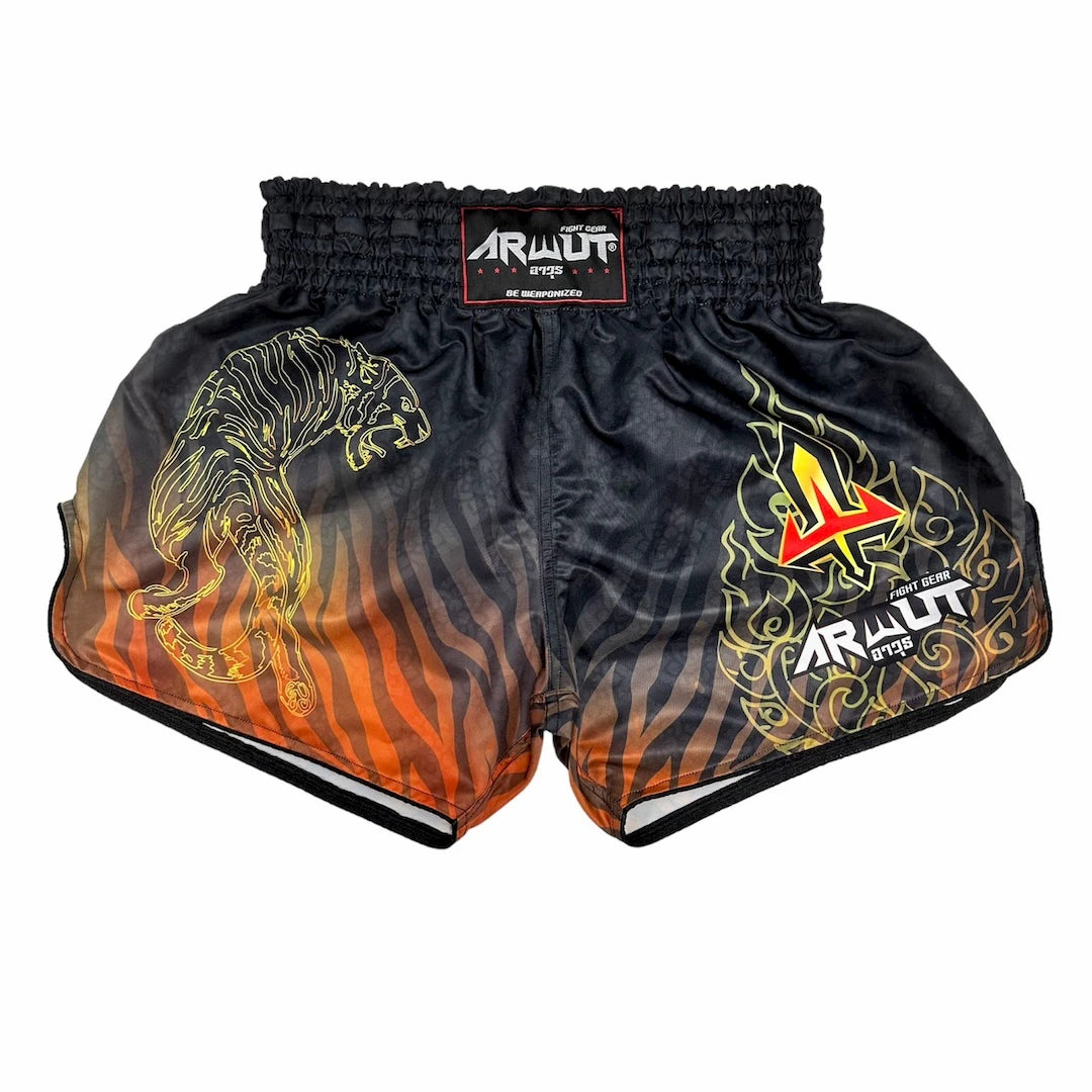 Black and orange Muay Thai shorts with tiger design and brand logo on a white background
