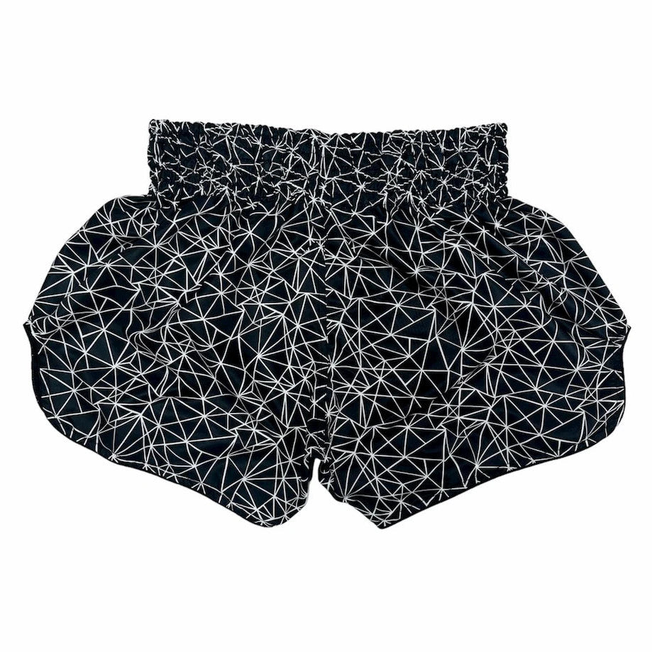 Black Muay Thai shorts with white geometric pattern on a white background