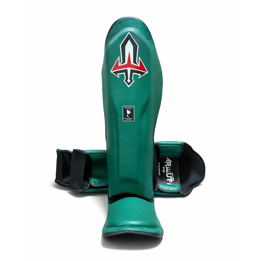 Green shin guards with a logo on a white background