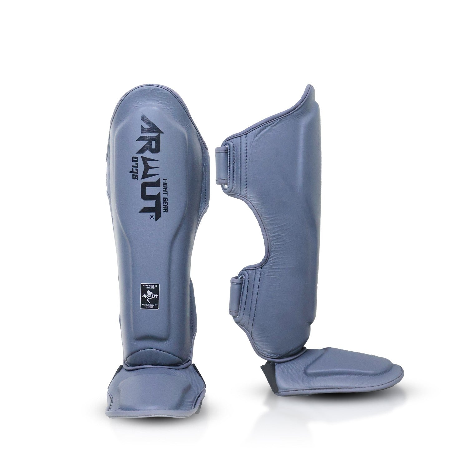 Pair of gray shin guards with a brand logo on a white background