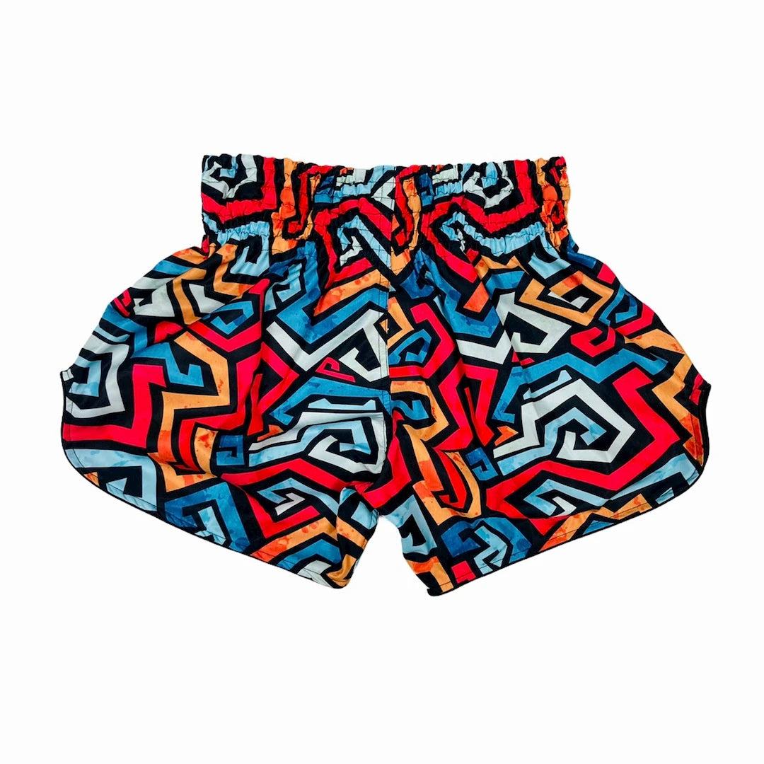 Colorful geometric patterned thai shorts on a white background