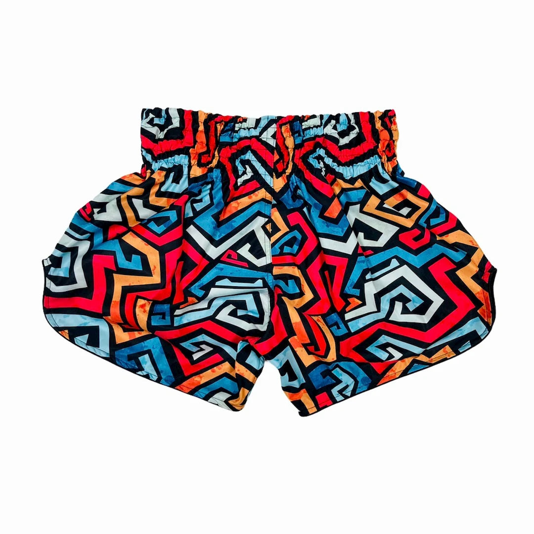Colorful geometric patterned Muay Thai shorts on a white background