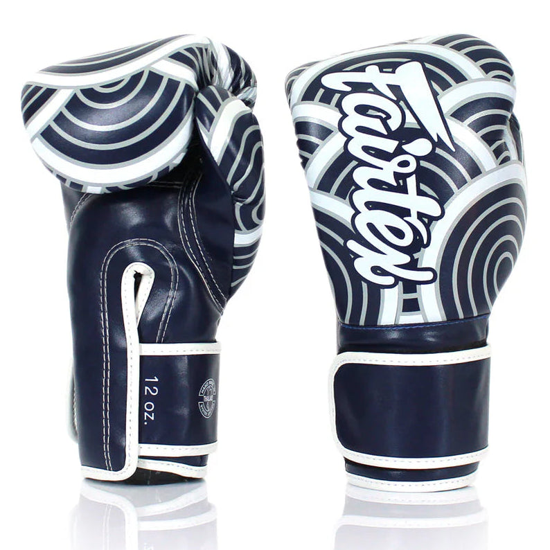 Pair of navy and white boxing gloves with 'Fairtex' branding on a white background