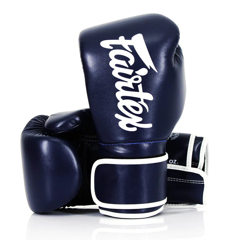 Navy blue boxing gloves with 'fairtex' branding on a white background