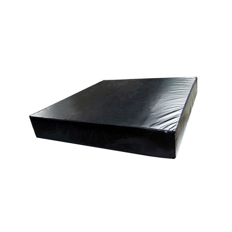 Black crash mat with reflective surface on a white background