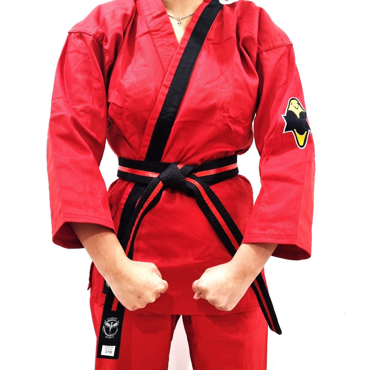 Person wearing a red martial arts uniform with a black belt on a white background