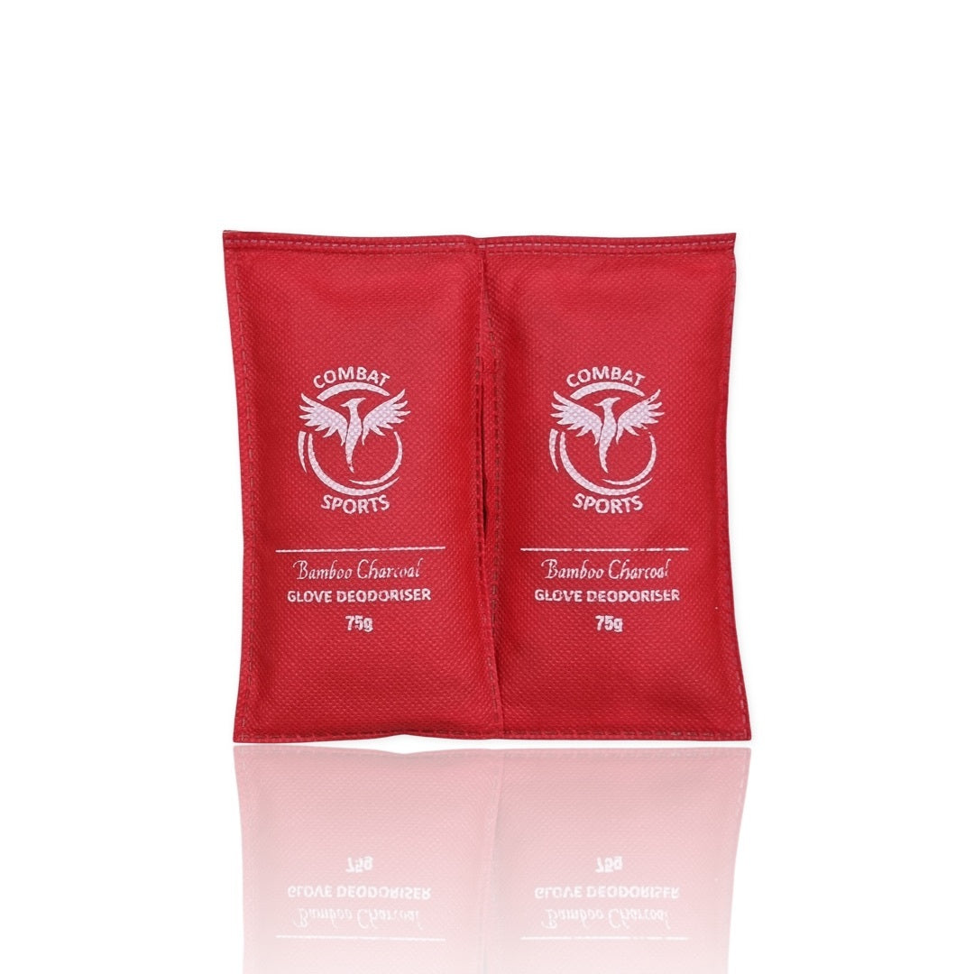 Two red 'Combat Sports' glove deodorizer packets on a white background