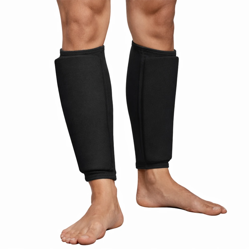 Black leg shin pads on a person's legs against a white background