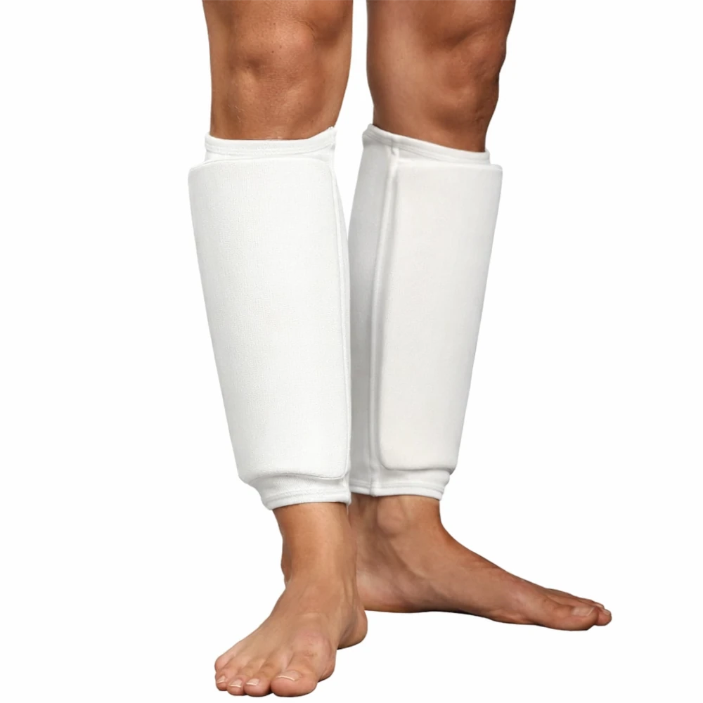 White shin pads on a person's legs against a white background