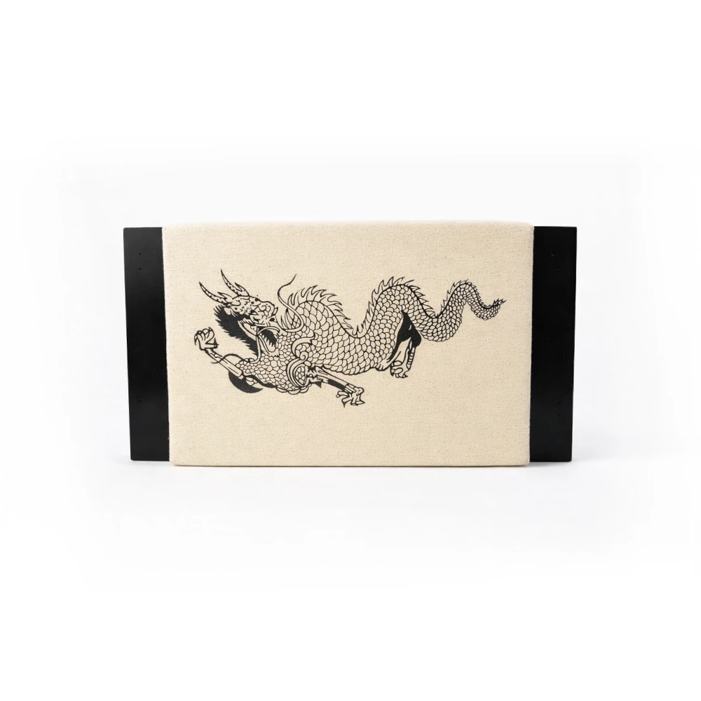 Rectangular punch pad with a black dragon design on a beige background