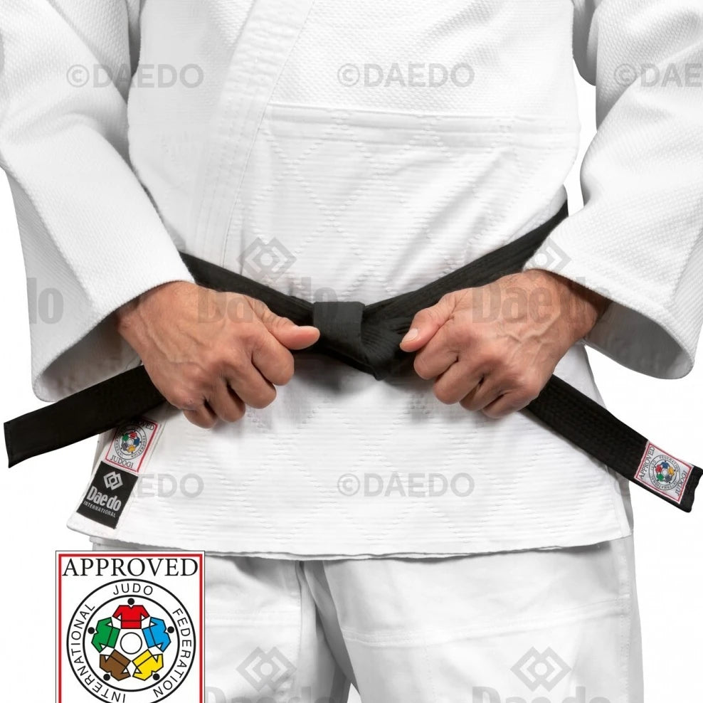 Male wearing a white martial arts uniform with a black belt, holding it with both hands, on a white background.