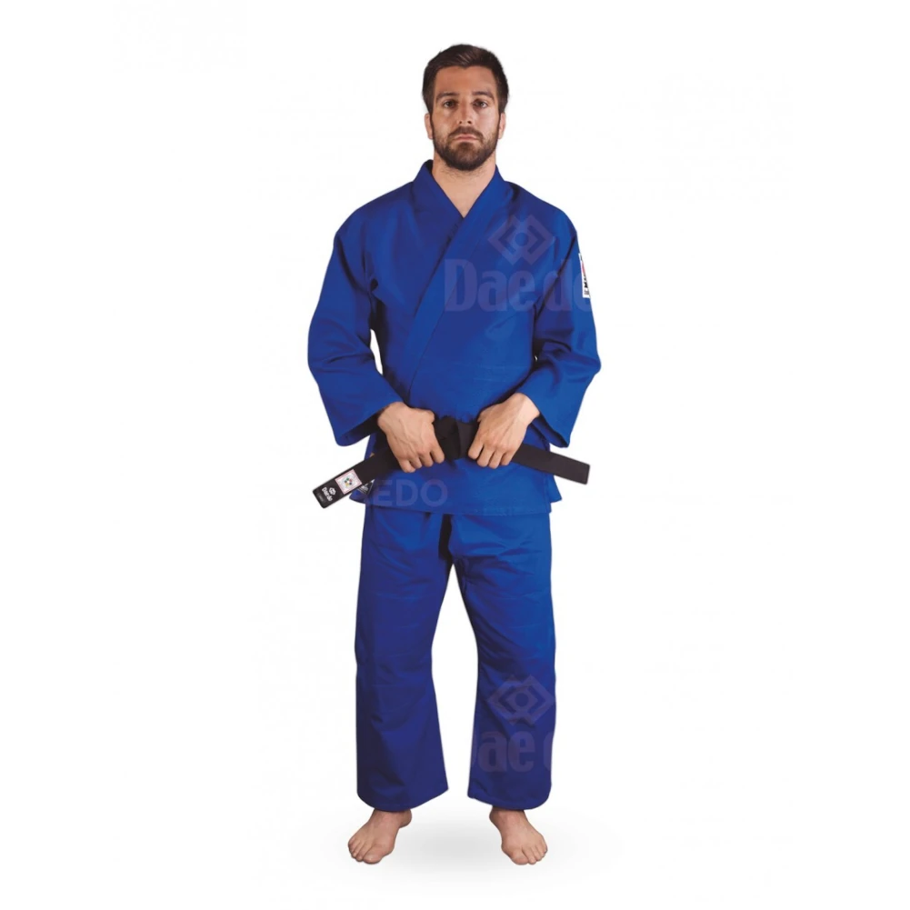 Man wearing a blue martial arts uniform with a black belt on a white background