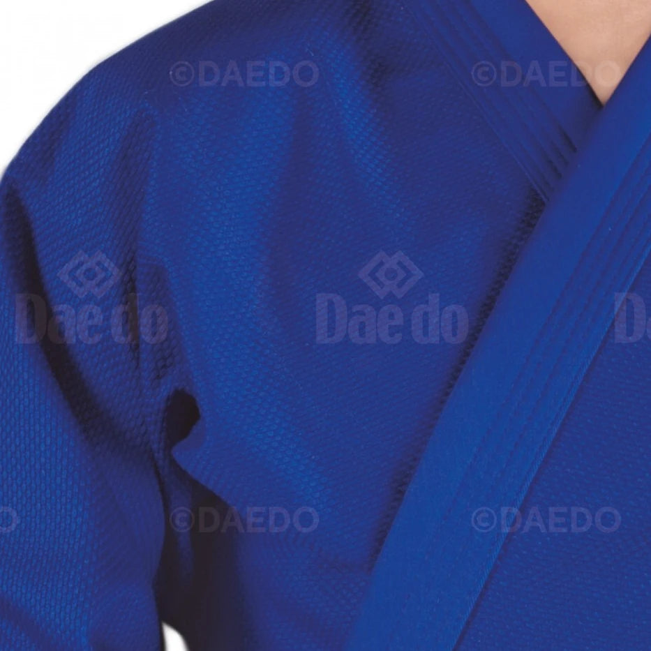 Close-up of a blue martial arts uniform with 'Daedo' branding.