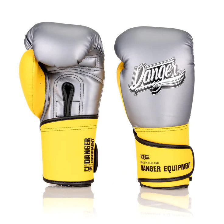 Pair of silver and yellow boxing gloves with 'Danger' branding on a white background