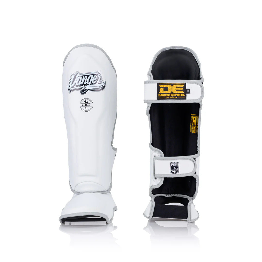 White Muay Thai shin guards with 'Danger' branding on a white background