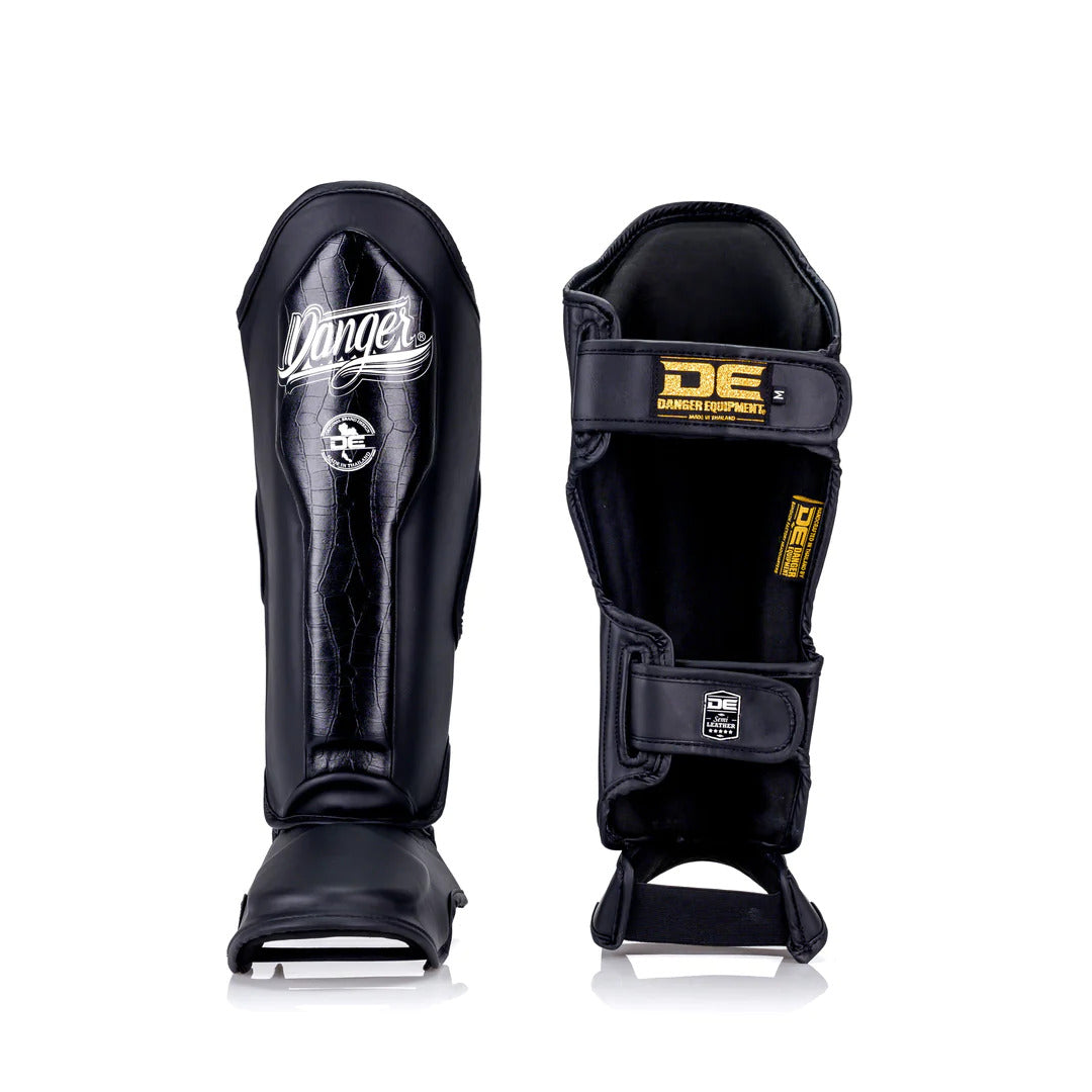 Black shin guards with 'Danger' branding on a white background