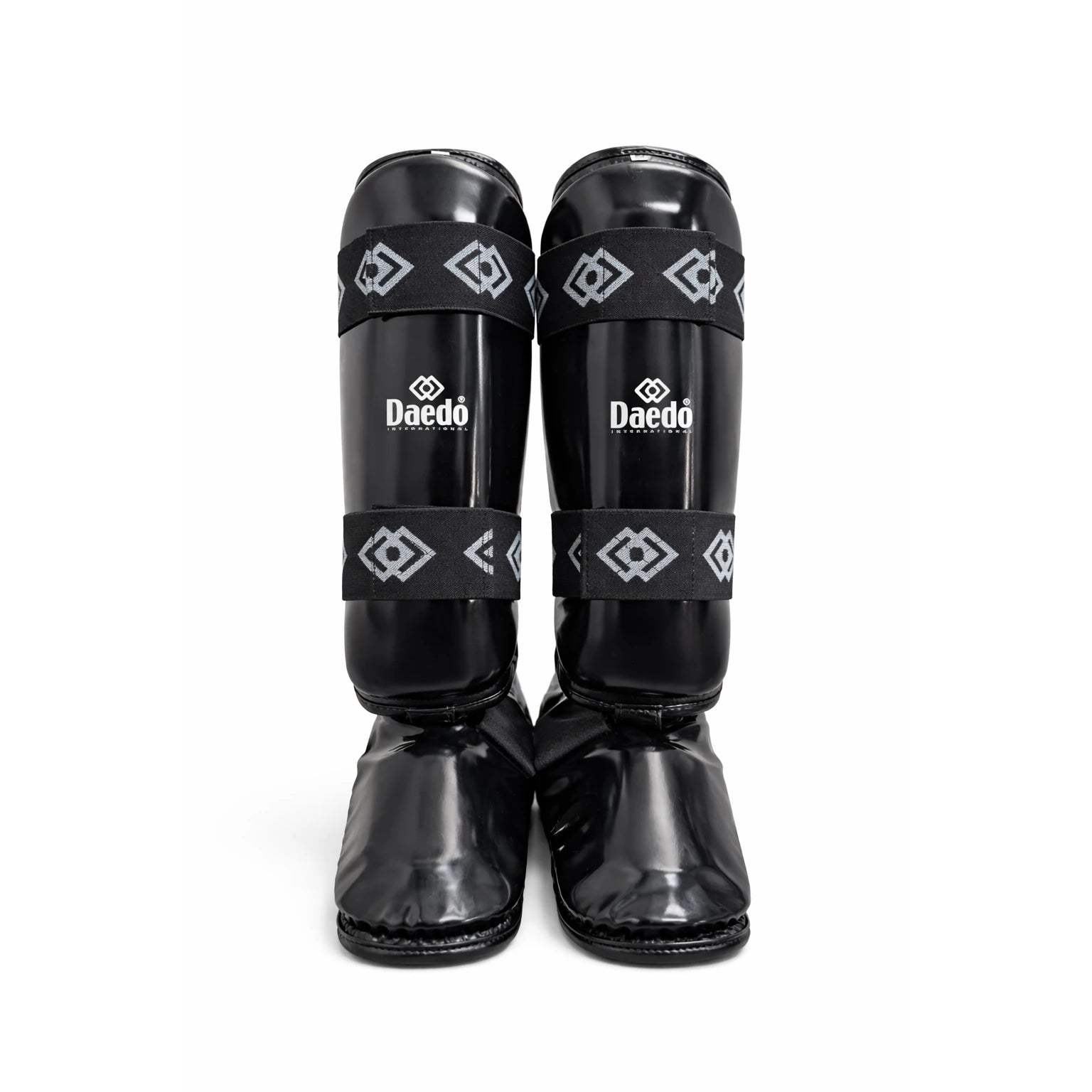 Pair of black shin guards with 'Daedo' branding on a white background