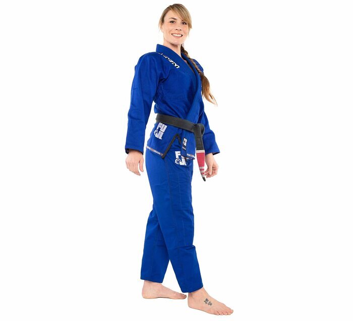 Woman wearing a Fuji blue martial arts uniform on a white background