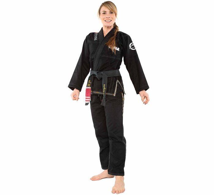 Woman wearing a black Fuji BJJ gi on a white background