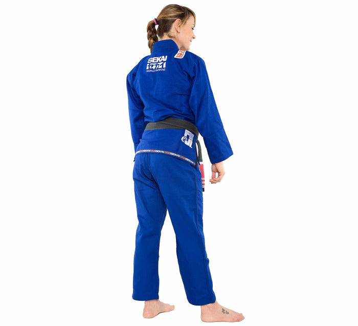 Woman wearing a blue Fuji martial arts uniform on a white background