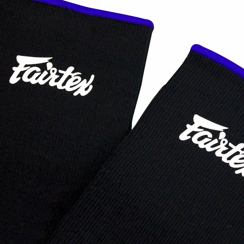 Black Fairtex ankle guards with blue trim on a white background