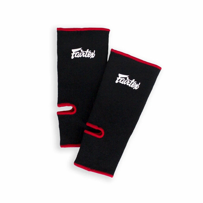 Pair of black anklets with red accents and visible branding on a white background