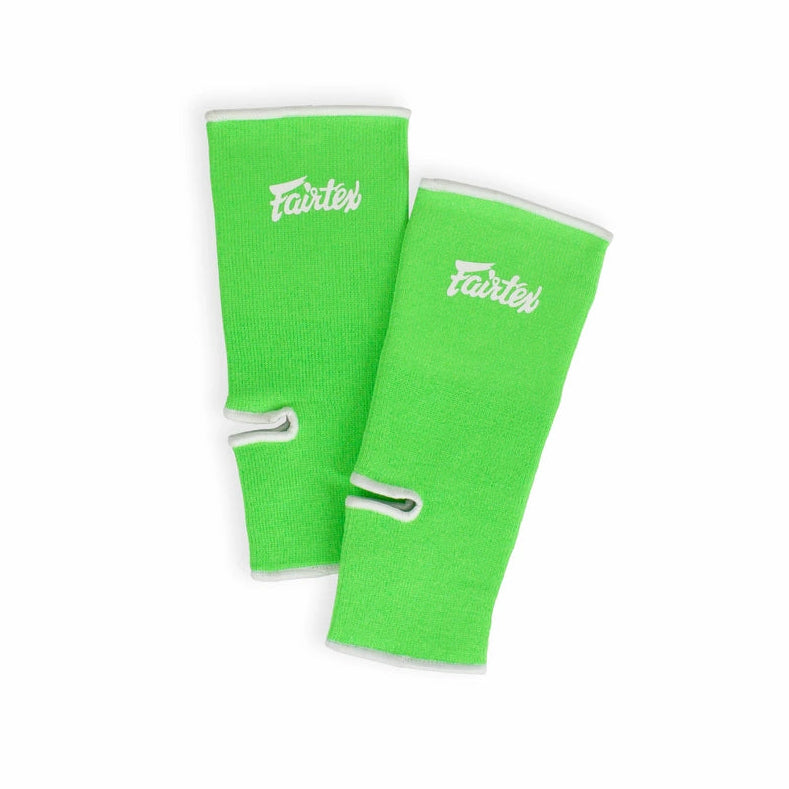 Two green ankle guards with a brand logo on a white background