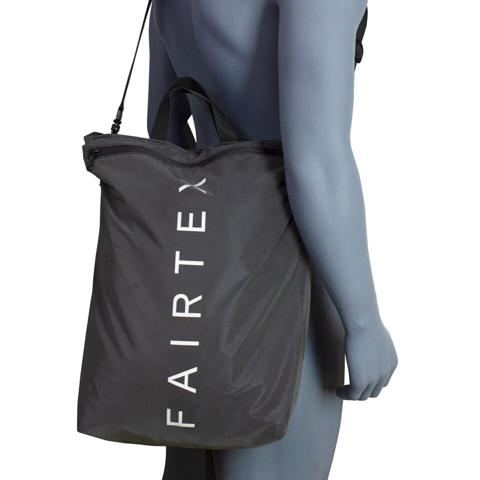 Person holding a Fairtex bag against a white background