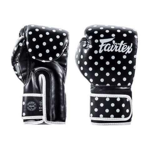 Black boxing gloves with white polka dots and Fairtex logo on a white background