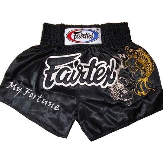Black Muay Thai shorts with Fairtex branding and dragon design on a white background