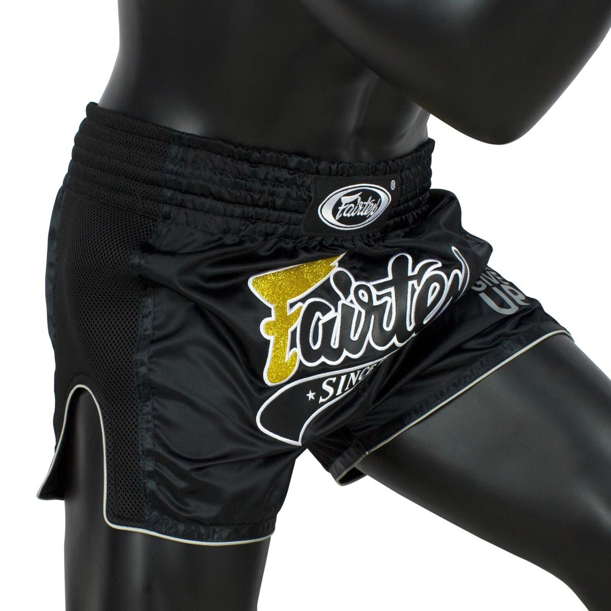 Black athletic Muay Thai shorts with Fairtex logo on a mannequin.