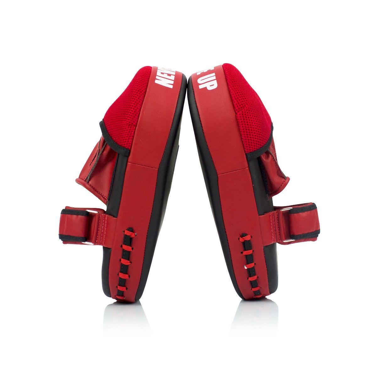 Side profile of red and black thai pads on a white background