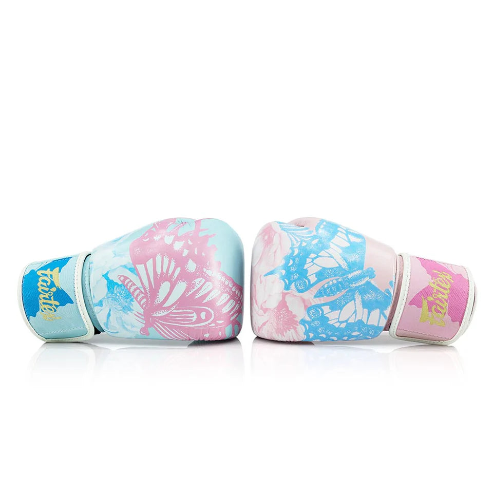 Pair of colorful Fairtex boxing gloves with floral design on a white background