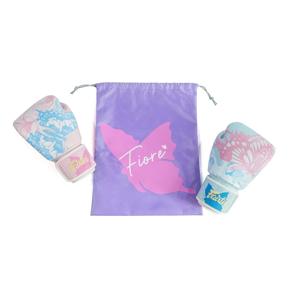 Pair of pink and blue boxing gloves with a purple drawstring bag featuring a butterfly design and 'Fiore' branding on a white background.