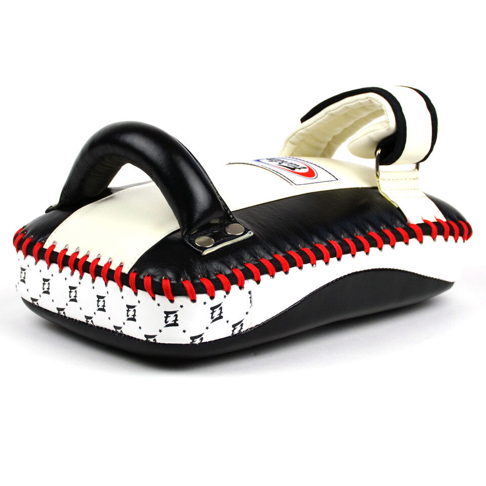 Black and white Muay Thai pad with red stitching on a white background