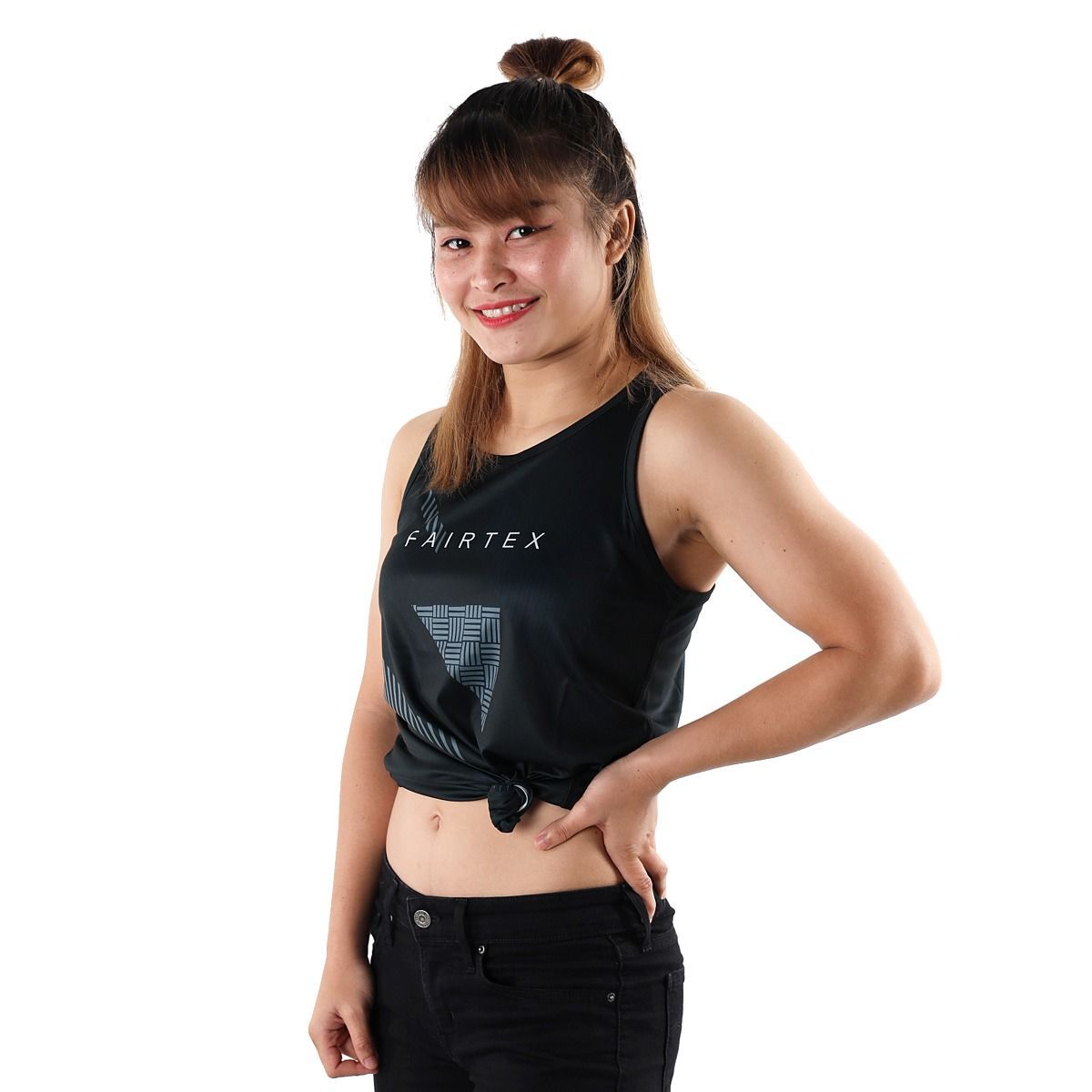 Woman wearing a black Fairtex tank top on a white background