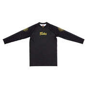 Black long-sleeve rash guard with gold logo and patterns on sleeves against a white background