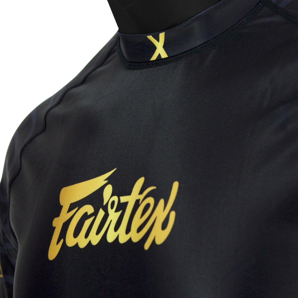 Black athletic rash shirt with yellow 'Fairtex' logo on a mannequin