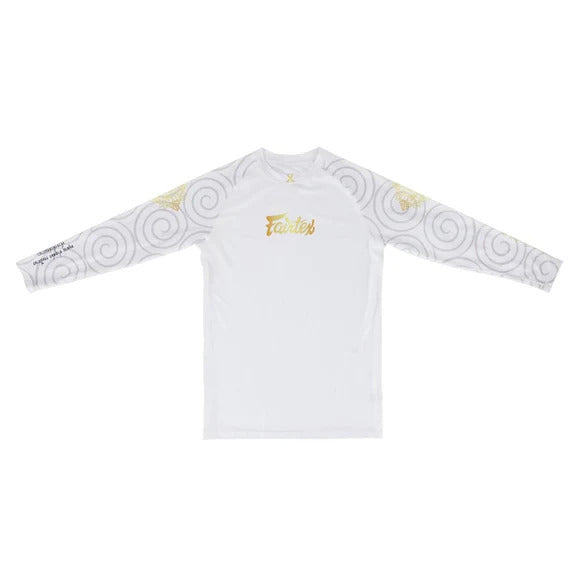 White long-sleeve rash guard with gold and black patterns on sleeves against a white background