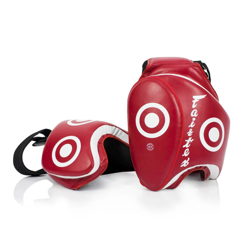 Red martial arts thigh pads with white circular designs on a white background
