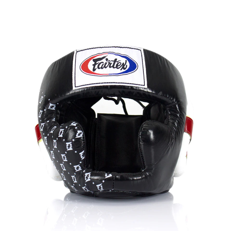 Black boxing headgear with white pattern on a white background, featuring the Fairtex logo.