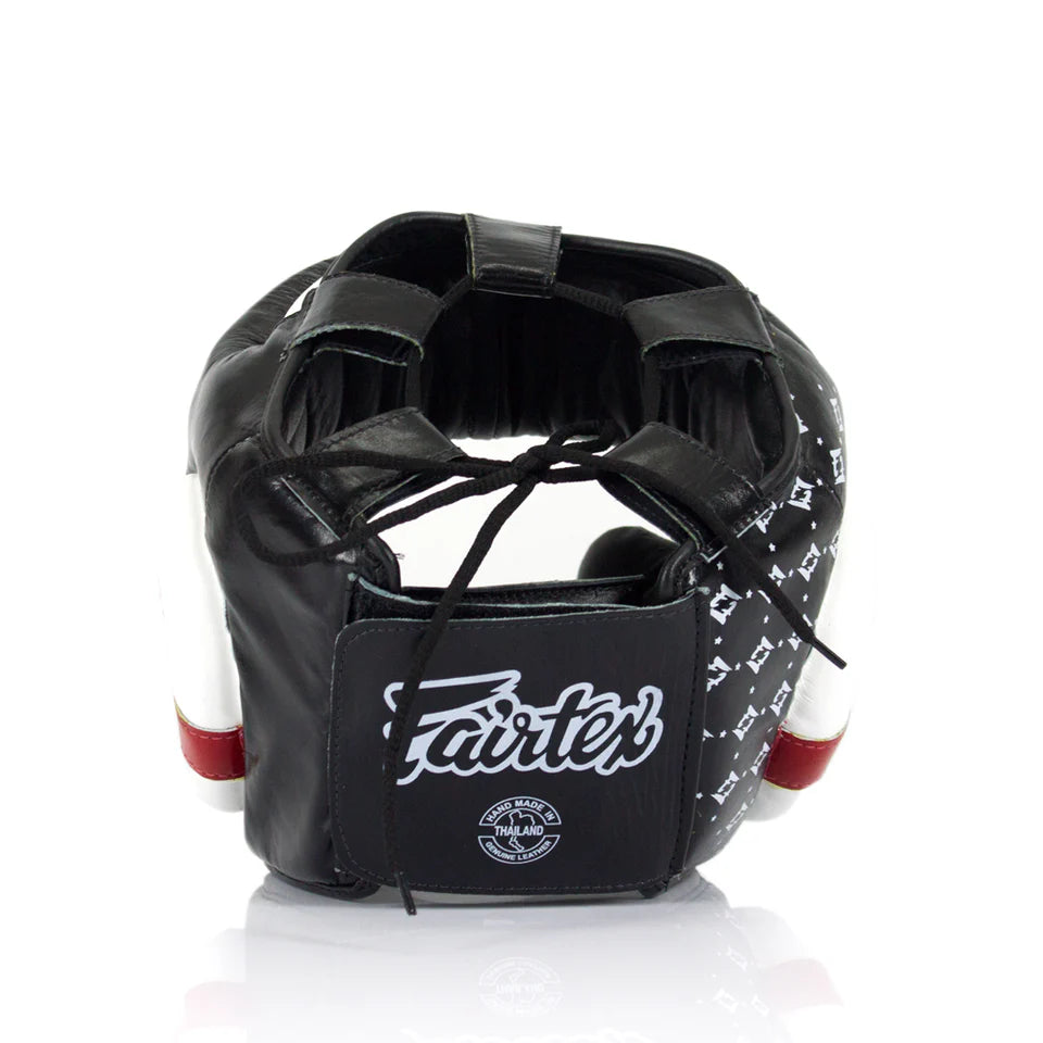 Rear profile of a black boxing headgear with visible Fairtex branding on a white background